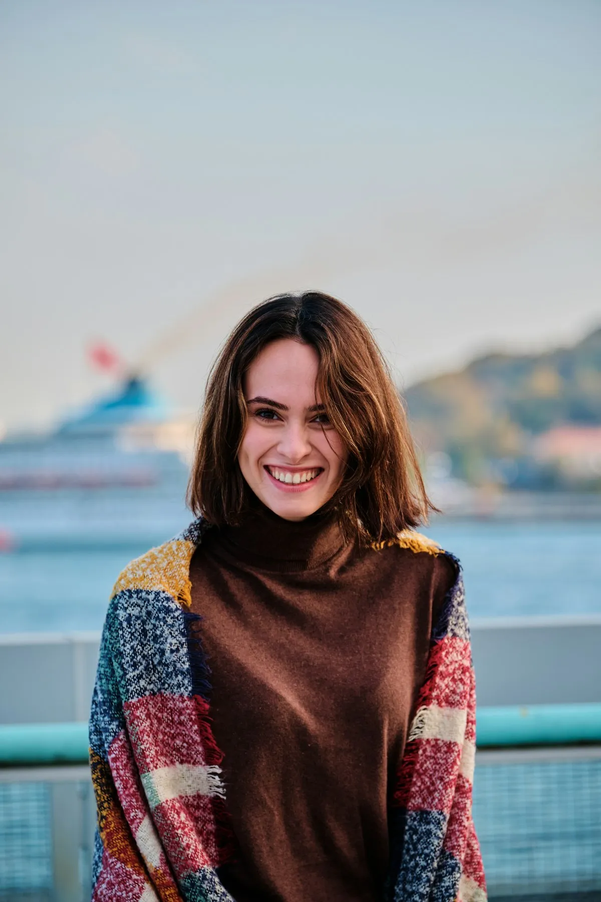Portrait of Maya Linden wearing a warm brown scarf